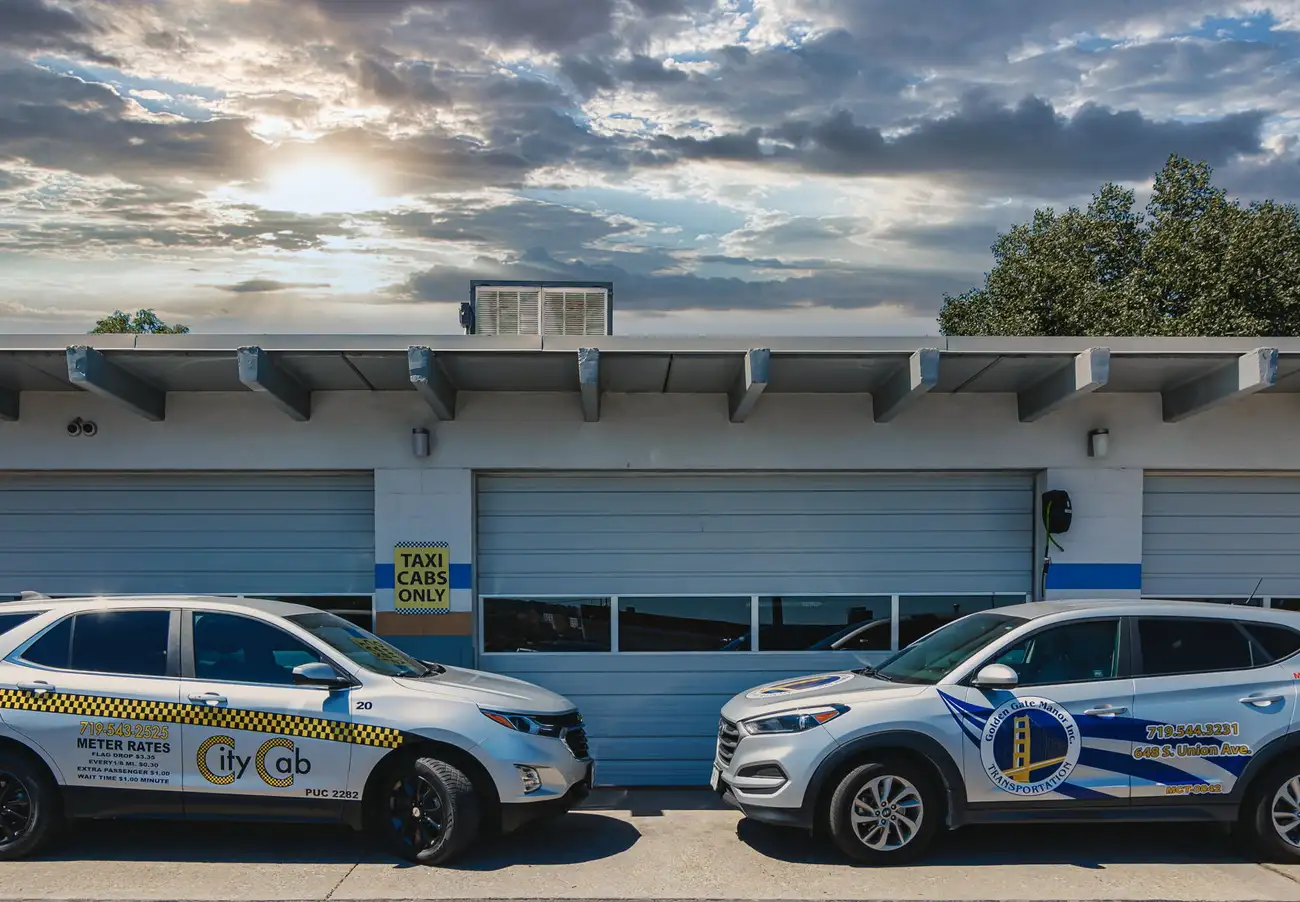 Pueblo City Cab and Golden Gate Manor Transportation vehicles in front of dispatch office.