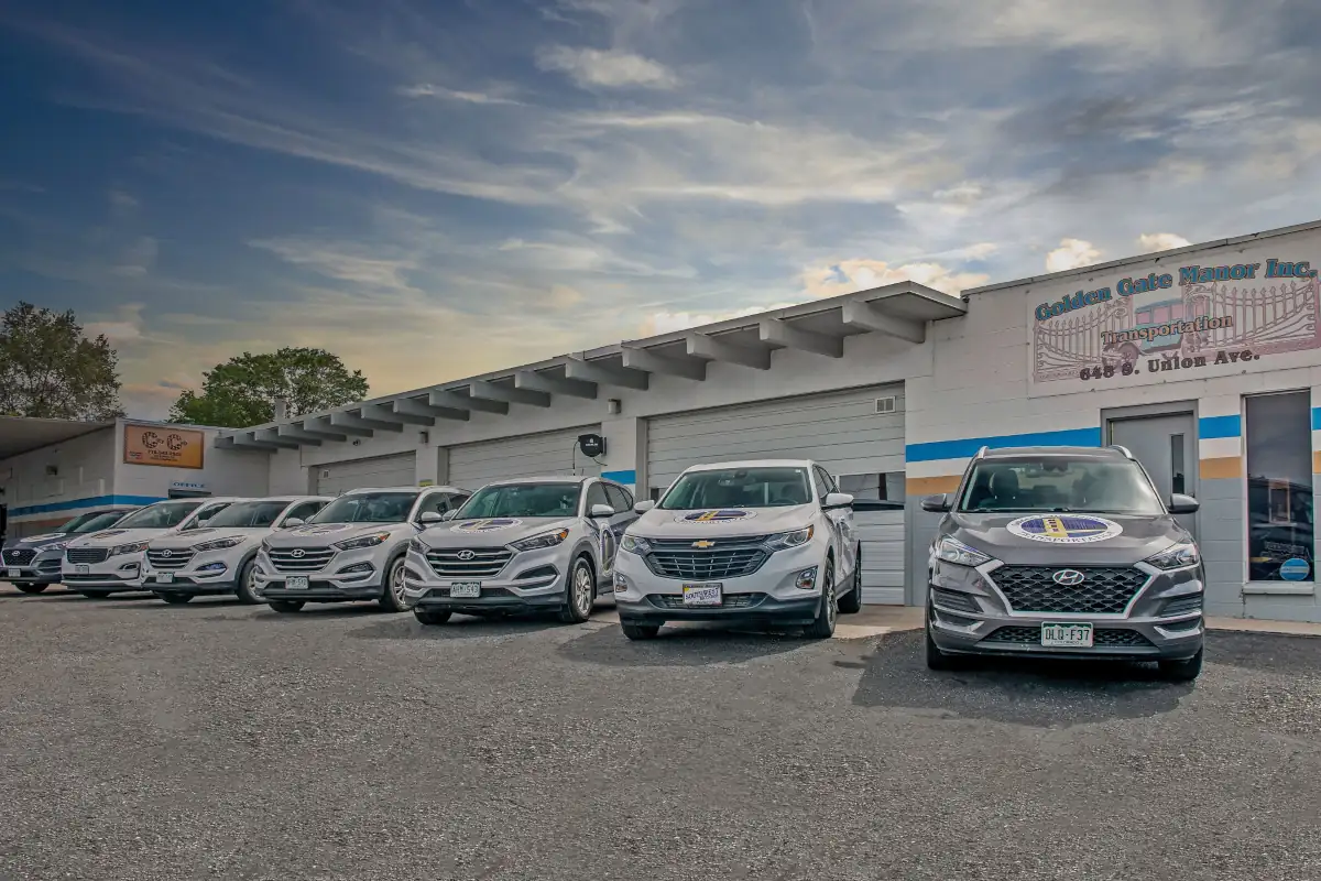 Golden Gate Manor fleet lined up in front of the transportation building.